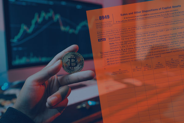 Image of a hand holding a physical Bitcoin. A computer in the background shows cryptocurrency price history on a chart. Overlaid on this image is a stylized version of IRS Form 8949.