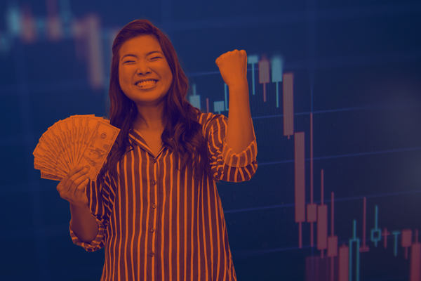 Stylized image shows a cryptocurrency price chart in the background with crypto prices declining. In the foreground is a woman excitedly pumping her fist while holding a handful of $100 bills.