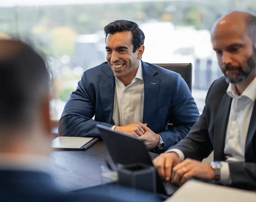 Attorney Andrew Gordon wearing a confident and relaxed smile during a legal meeting.